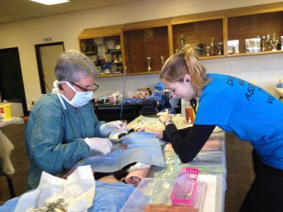 Liz spays a cat while Shaena assists.